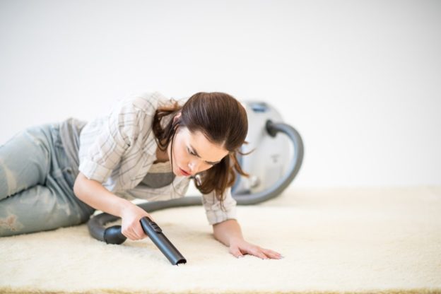 woman vacuuming floor
